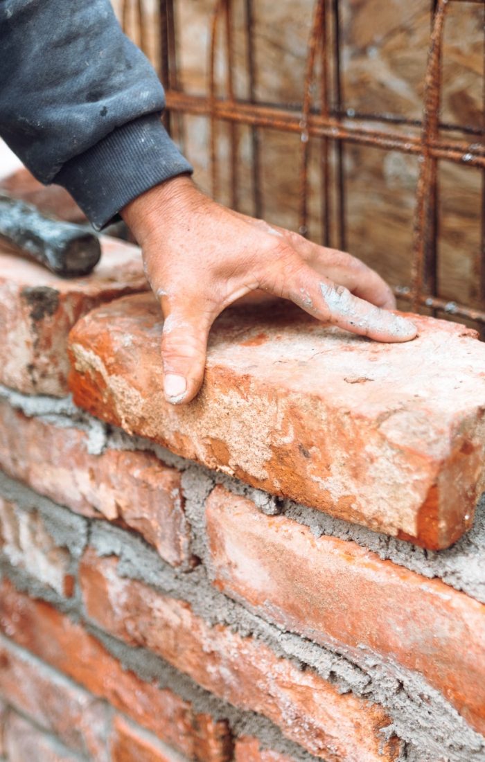 bricklayer-worker-installing-brick-masonry-on-exterior-wall-with-hands-and-tools.jpg